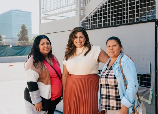 Photo courtesy. Adriana Abich, the CEO of Camino Nuevo Charter Academy, is pictured in the center along with two parents.