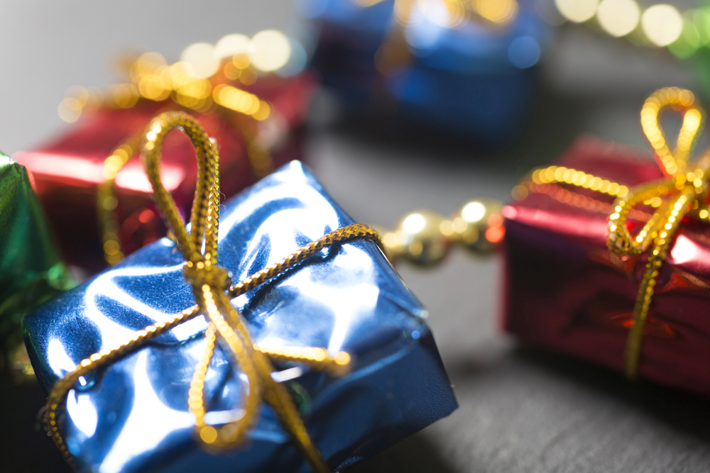 Small Christmas gifts decorations on a dark slate surface